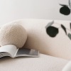 a couch with a book on it near a plant