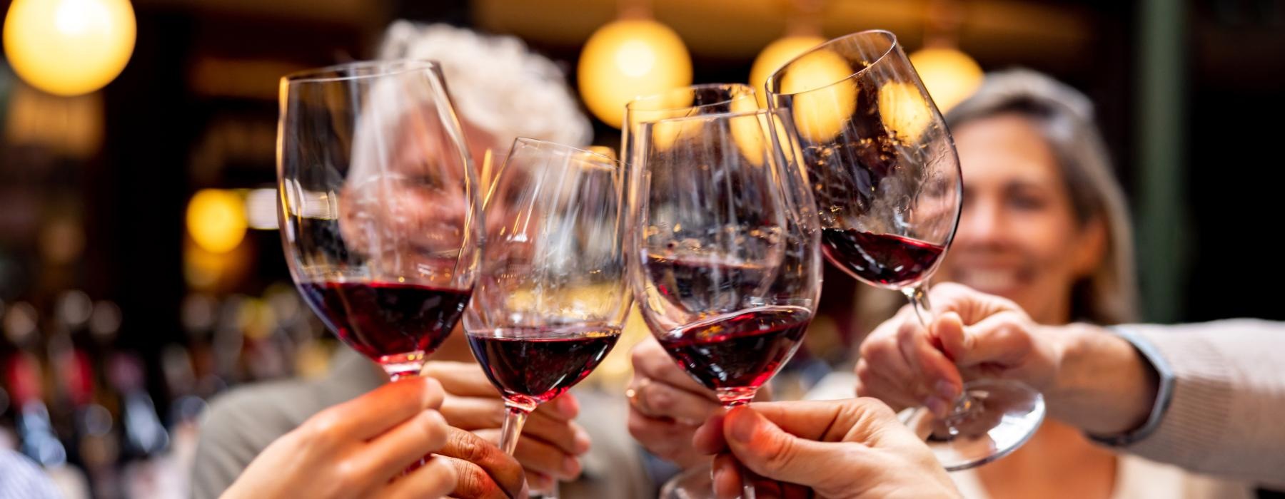 a group of people holding wine glasses